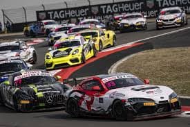 Toyota Supra GT4 leading a Mercedes-AMG GT4 on track
